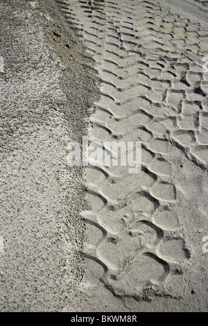 Pneumatici escavatore impronta sulla cava di sabbia bianca pattern Foto Stock