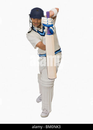 Cricket battitore la riproduzione in avanti corsa difensiva Foto Stock