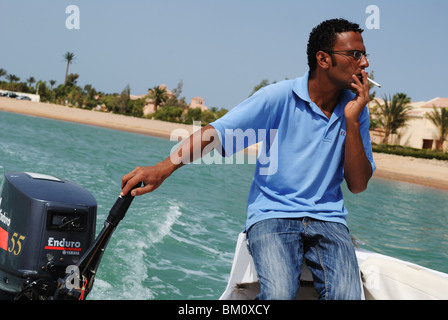 Giovane uomo alla guida di barche a motore sul Mar Rosso, El Gouna Foto Stock