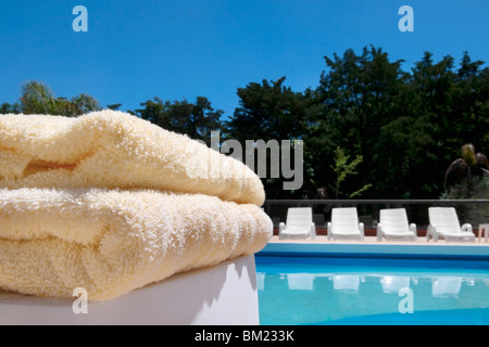 Close-up di asciugamani e sedie a sdraio a bordo piscina Foto Stock