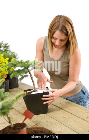 Giardinaggio - donna con albero di bonsai e piante prendersi cura Foto Stock