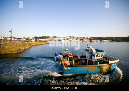 Blu di lavoro barca da pesca lasciando Saundersfoot harbour Pembrokeshire su un luminoso giorno di sole Foto Stock