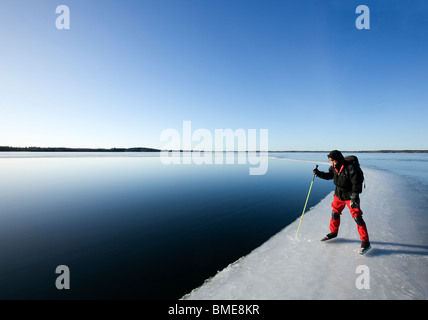 Uomo in piedi vicino al lago Foto Stock