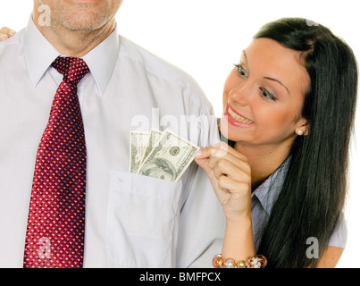 Una giovane donna tira il denaro al di fuori di un uomo di tasca. Dollaro Foto Stock