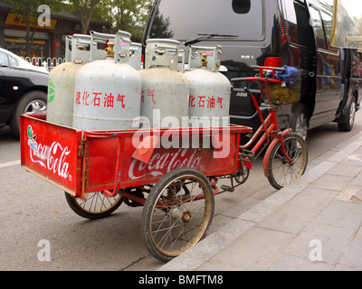 Triciclo Cargo piena di bombole di gas parcheggiato sulla strada a Pechino in Cina Foto Stock