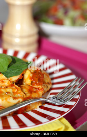 Cucinato al momento in italiano o in stile Mediterraneo autentico di Spinaci e Ricotta Tortelloni con insalata contro uno sfondo bianco con n. di persone Foto Stock