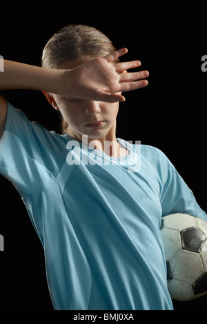 Giocatore di calcio e palla Foto Stock