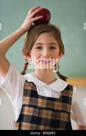 Bambino in possesso di un Apple sulla sua testa Foto Stock