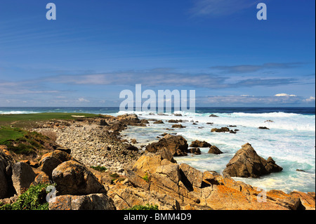 Onde infrangersi lungo la costa rocciosa, punto Joe, Pebble Beach California Coast Brandt di cormorani sul rock in distanza Foto Stock