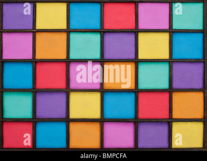 Sabbia multicolore pattern in una griglia di legno Foto Stock
