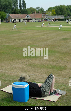 Uno spettatore guarda una partita di cricket a Sudbury, Suffolk, Inghilterra. Foto Stock