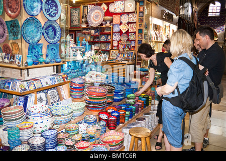 I turisti alla ricerca di ceramica per la vendita nel Grand Bazaar, Istanbul, Turchia Foto Stock