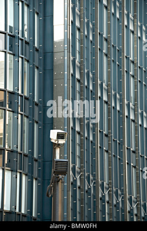 Una telecamera TVCC in una città di London street con un ufficio moderno blocco dietro Foto Stock