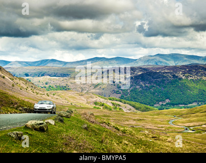 Auto sportiva guida su Honister Pass in inglese il Parco Nazionale del Distretto dei Laghi, Cumbria, England, Regno Unito Foto Stock