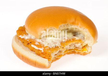 Filetto di pesce in sandwich con formaggio e coperto di salsa tartara su bun con un morso prese da esso su sfondo bianco, ritaglio. Foto Stock