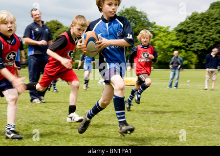 Ragazzi giocando a rugby a prendere parte Brighton & Hove Festival Internazionale dello Sport in Preston Park. Foto Stock