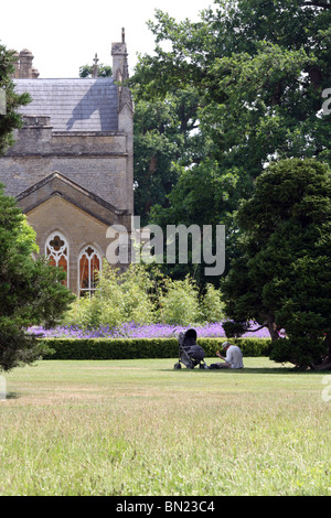 Uomo e bambino godere di un picnic nei giardini di Cotswold Wildlife Park, Oxfordshire Foto Stock