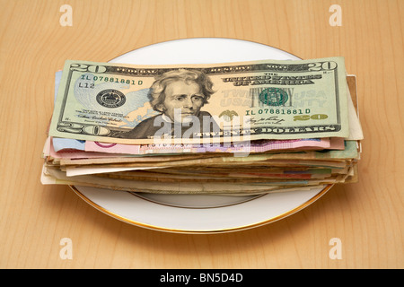 Pila di denaro sulla piastra 20 dollari Dollaro sulla parte superiore Foto Stock