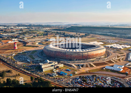 Vista aerea della FIFA 2010 Soccer City Stadium conformata come un calabash con lo skyline di Johannesburg in distanza Foto Stock