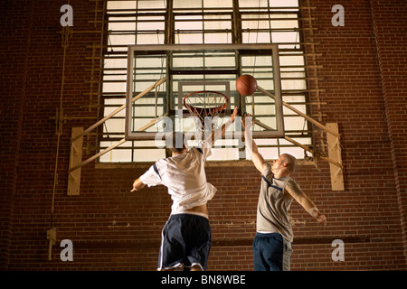 Gli uomini giocare a basket Foto Stock