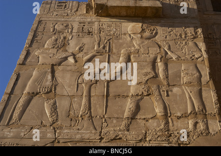 Tempio di Ramses III. Rilievo raffigurante Ramses III facendo offerte prima dio Ra. Nuovo Regno. Tebe. Medinet-Habu. L'Egitto. Foto Stock