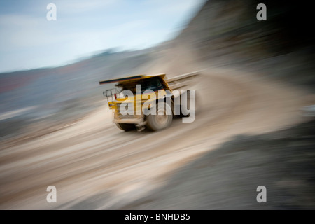 Grande scavatrice haul dump carrello nella voce di cava verso il basso su strada sterrata con il movimento nel mio ambiente Foto Stock