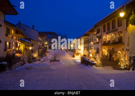 Gruyères Svizzera Canton Friburgo città piccola fontana case case illuminate Col de Pontins ILLUMINAZIONE DI NATALE Foto Stock