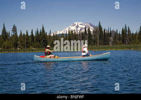 I cittadini anziani pagaiare in canoa sul lago Hosmer lungo la cascata Autostrada dei Laghi nel centro di Oregon Foto Stock