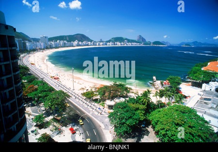 Alberghi, edifici di appartamenti e di sabbia bianca lungo la spiaggia di Copacabana a Rio de Janeiro con il Pan di Zucchero il picco alla fine Foto Stock