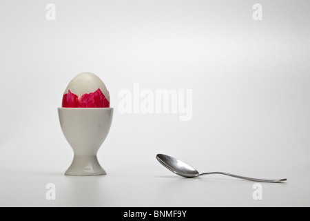 Uovo di Pasqua uovo cibo porcellana porcellana mug eggcup tagliare bianco rosso cucchiaio Foto Stock