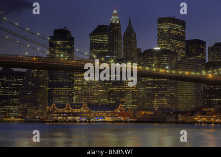 Ponte di Brooklyn, East River, South Street Seaport, e abbassare la skyline di Manhattan al crepuscolo in New York City. Foto Stock