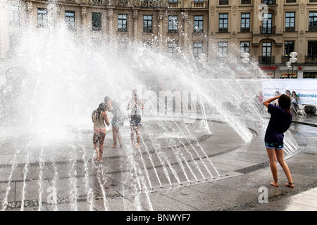 La gente a giocare in Karlsplatz Stachus Fontana, Monaco di Baviera Germania Foto Stock