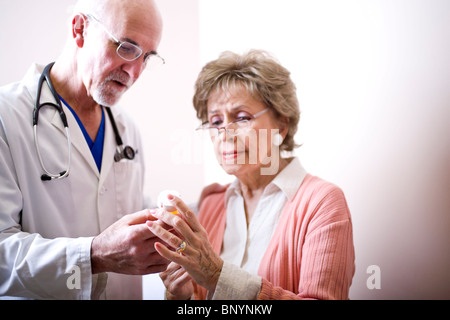 Donna senior con medico di prescrivere medicine Foto Stock