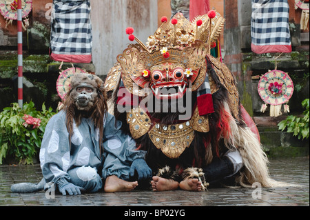 La scimmia e Barong ballerini sotto la pioggia durante il barong dance in Ubud, Bali. Foto Stock