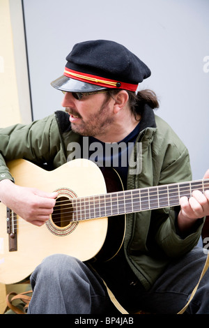 Busker suonando la chitarra su Chmielna street, Varsavia Polonia. Foto Stock