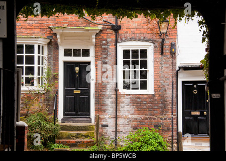 Case in segale, Sussex England visto attraverso un arco a una via Foto Stock