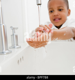 African American boy il lavaggio mani Foto Stock