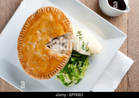 Pub inglese tradizionale cibo - grande torta con mash e verdure Foto Stock