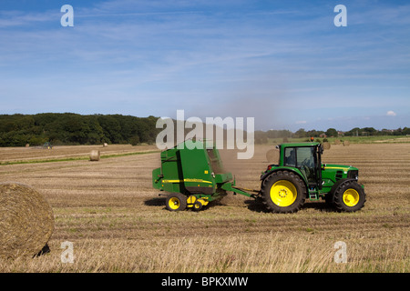 Imballatrici John Deere, rotopressa a camera variabile. Una fattoria. Tractor Tractor Straw at Mere Brow, Hesketh Bank, Southport, Lancashire, Regno Unito Foto Stock