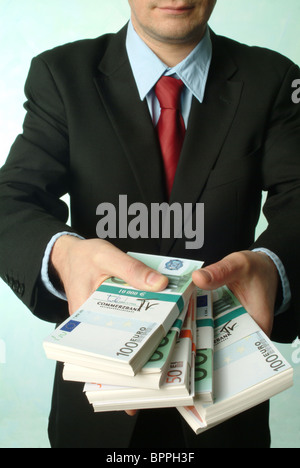 L'uomo azienda di mazzette di banconote Foto Stock