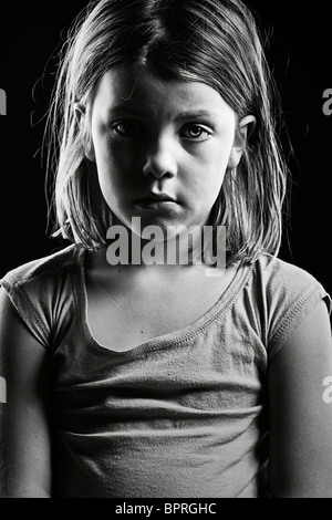 Potente in bianco e nero girato da una triste guardando bambino Foto Stock