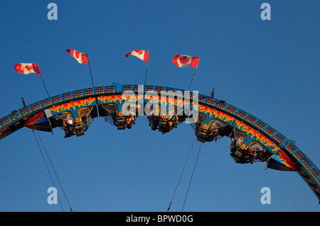 Piloti appeso a testa in giù su un roller coaster ride al Canadian National Exhibition CNE luna park midway fiera Toronto Canada bandiere Foto Stock