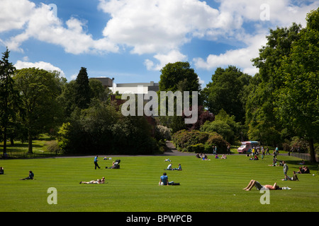 In Irlanda del Nord, Belfast, il Giardino Botanico con persone di relax al sole. Foto Stock