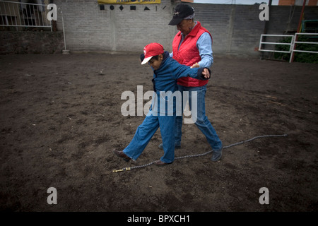 Terapista equino Guadalupe Pena guide un ragazzo autistico attraverso un esercizio a piedi durante una terapia di cavallo sessione a Città del Messico Foto Stock