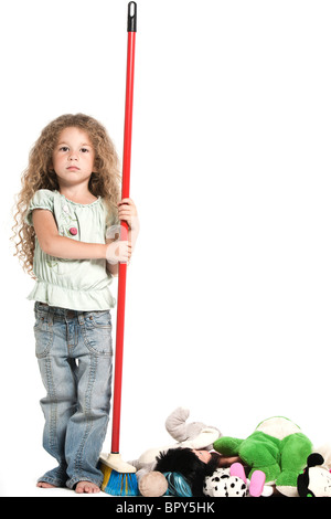 Caucasian bambina giocattoli di spazzamento serio studio isolato su sfondo bianco Foto Stock