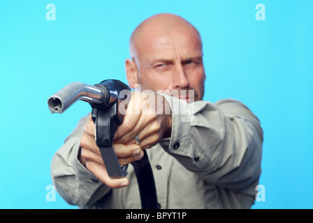 Uomo con un ugello di benzina come una pistola Foto Stock