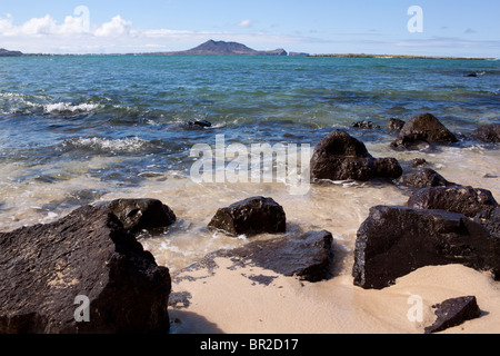 Rocce laviche, l'oceano, le montagne paesaggio in Hawaii Foto Stock