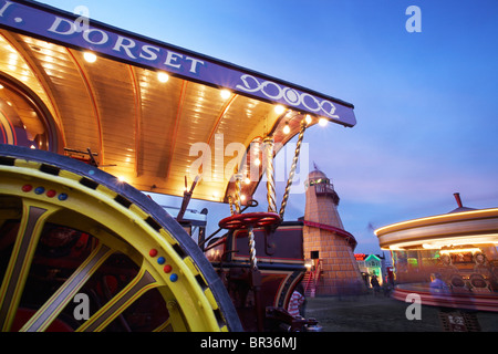 Mattatore del motore a vapore, Helter Skelter e merry-go-round alla grande Dorset fiera del vapore, Dorset, Regno Unito 2010 Foto Stock