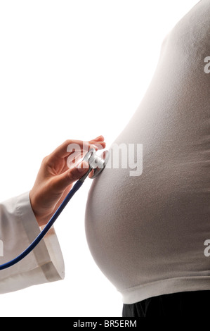 Pregant donna con stetoscopio medico Foto Stock