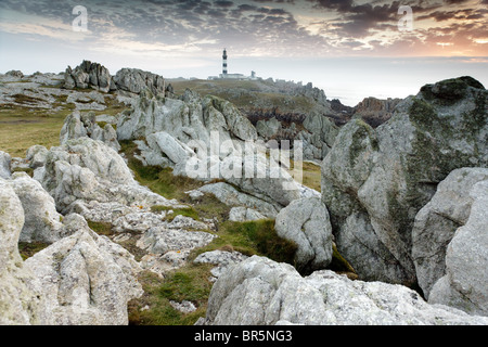 Isola di ouessant costa rocciosa al crepuscolo con creac'h lighthouse, Bretagna, Finisterre, Francia Foto Stock